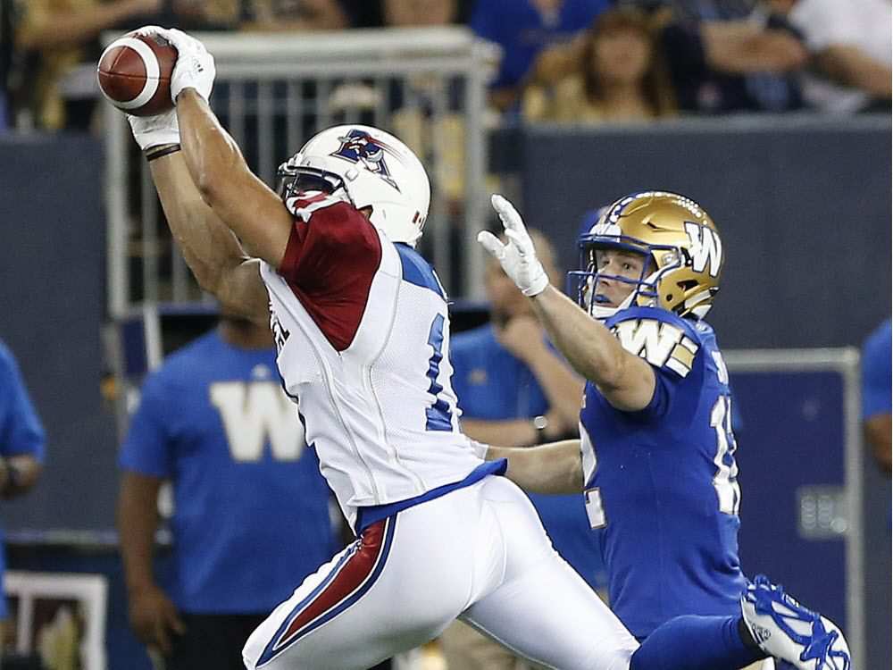 Montreal Alouettes' Chip Cox (11) intercepts a pass intended for Winnipeg Blue Bombers' Ryan Smith (12) during the first half of CFL action in Winnipeg Friday, June 24, 2016.
