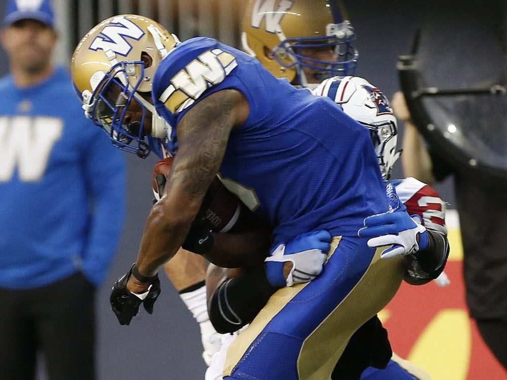 Winnipeg Blue Bombers' Chris Randle (8) intercepts a pass intended for Montreal Alouettes' Tyrell Sutton (20) during the first half of CFL action in Winnipeg Friday, June 24, 2016.