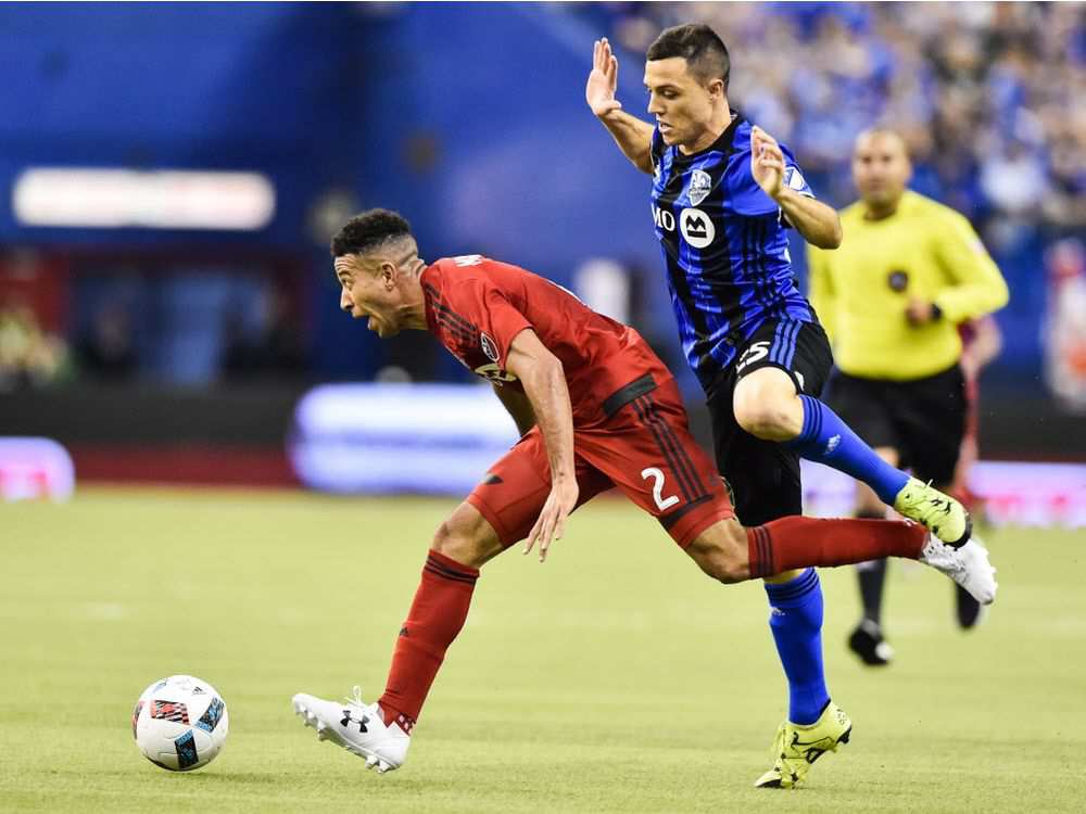 Donny Toia of the Montreal Impact challenges Justin Morrow of Toronto FC during first leg of the MLS Eastern Conference finals at Olympic Stadium on November 22, 2016 in Montreal.